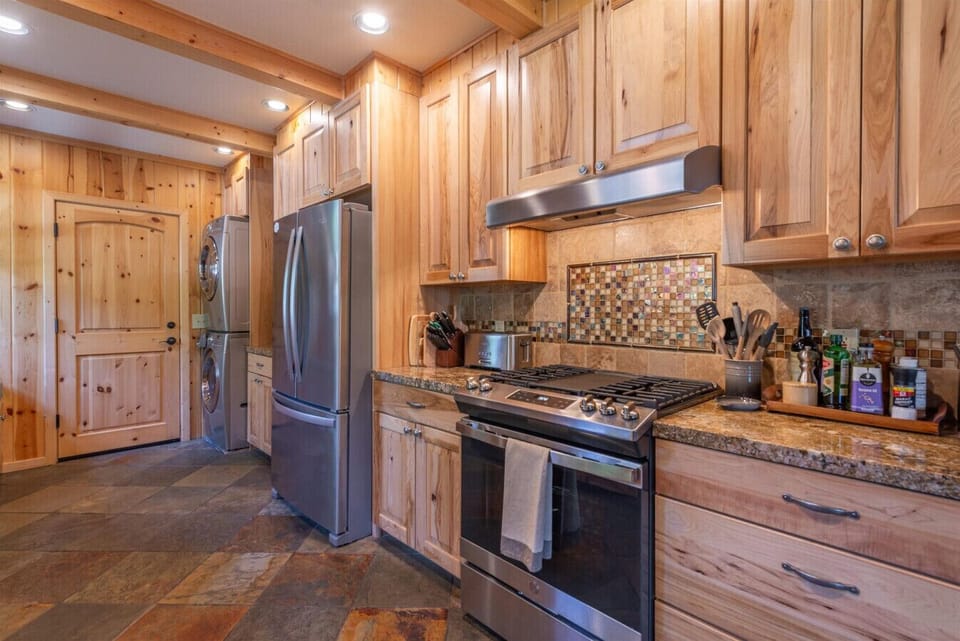 Well appointed kitchen with granite counter tops and stainless steel appliances.