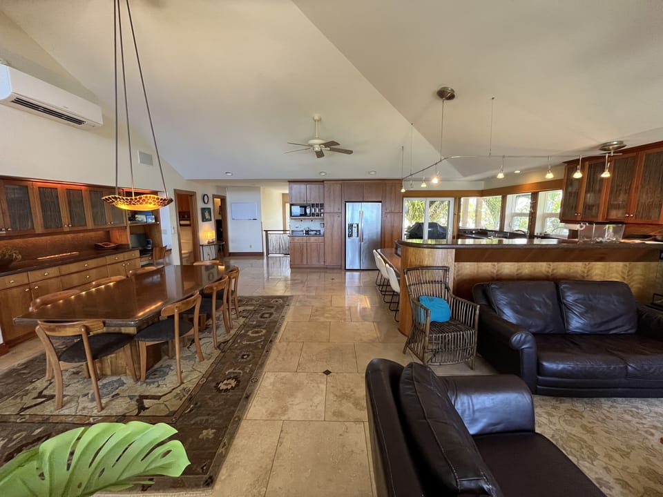 Living room, Dining room, & Kitchen, w/ travertine tile & high-pitched ceiling 