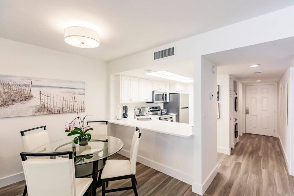 Dining area, kitchen entrance, and showing the washer/dryer as well.