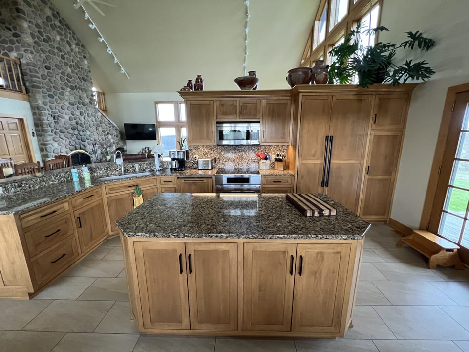 Kitchen island with appliances in background.