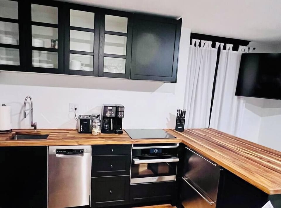 Newly remodeled kitchen with Miele speed oven, induction cooktop, dishwasher, and under-counter fridge/freezer drawers
