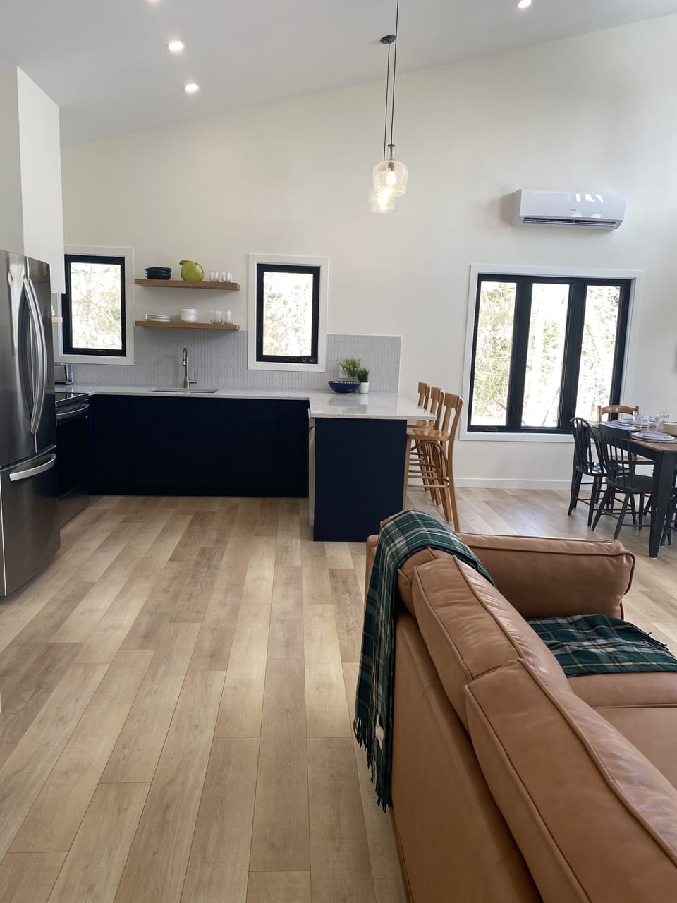 Bright and modern open concept living area - kitchen, dining and living areas