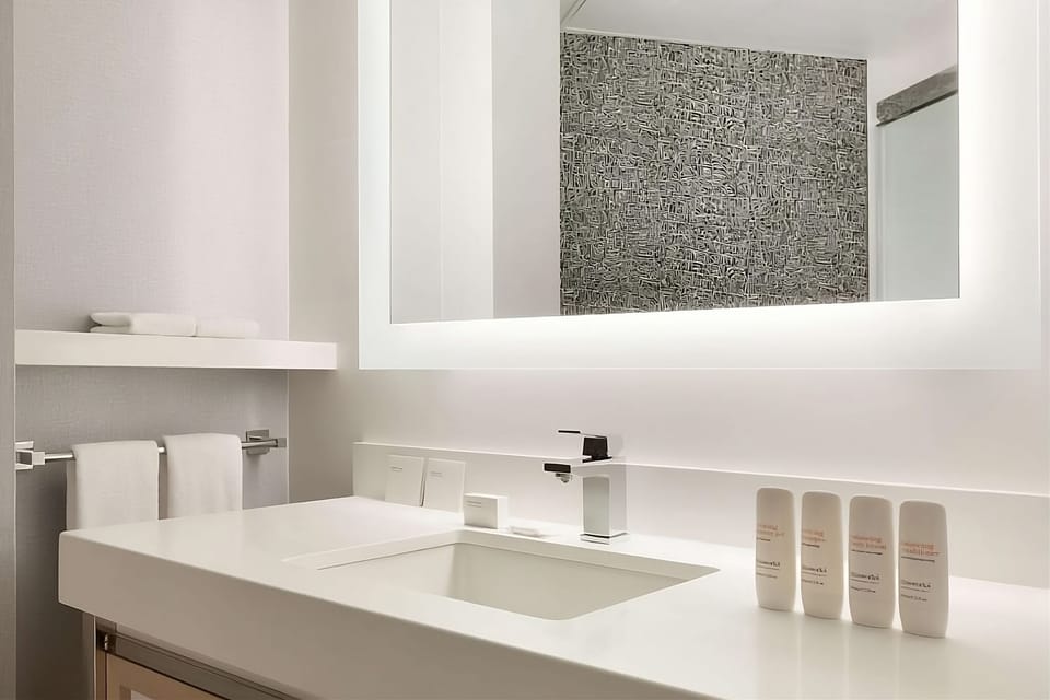 Refresh at a spa-clean vanity with bright mirror lighting.