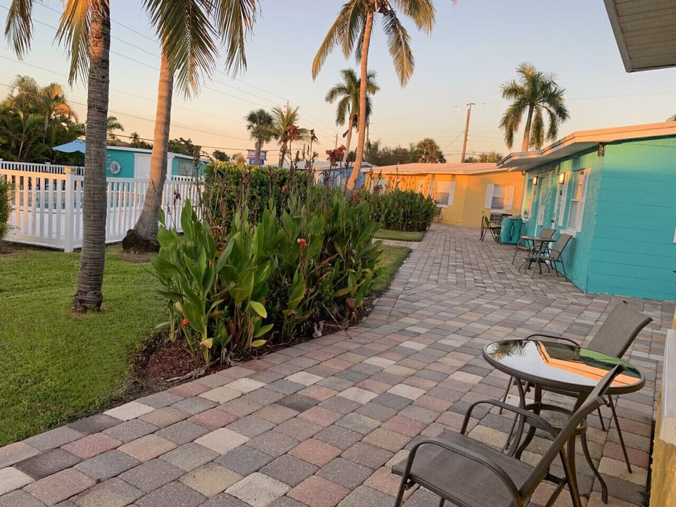 Paved garden patio offering a peaceful poolside experience for guests.