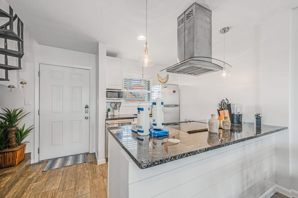 Your modern kitchen awaits with gleaming granite counters and stainless steel appliances, perfect for preparing memorable meals during your stay.