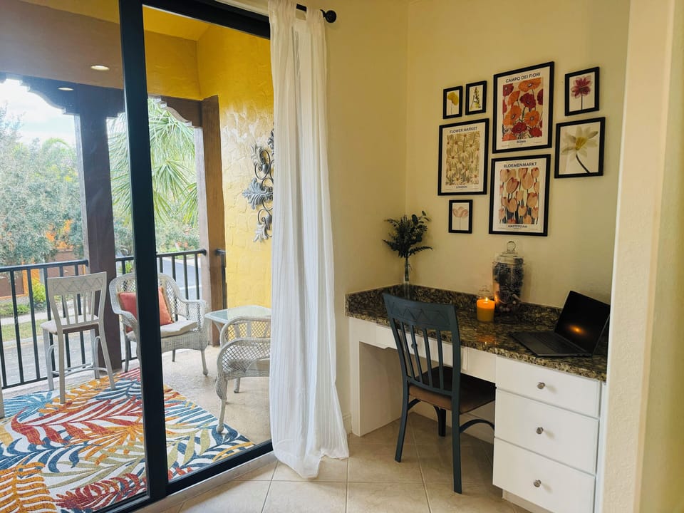Sitting area/desk adjacent to kitchen and outdoor balconey.