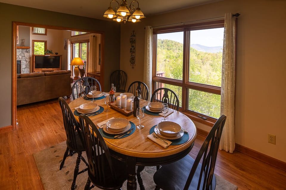 Dining with 2 extra chairs displaying picture window with long range views