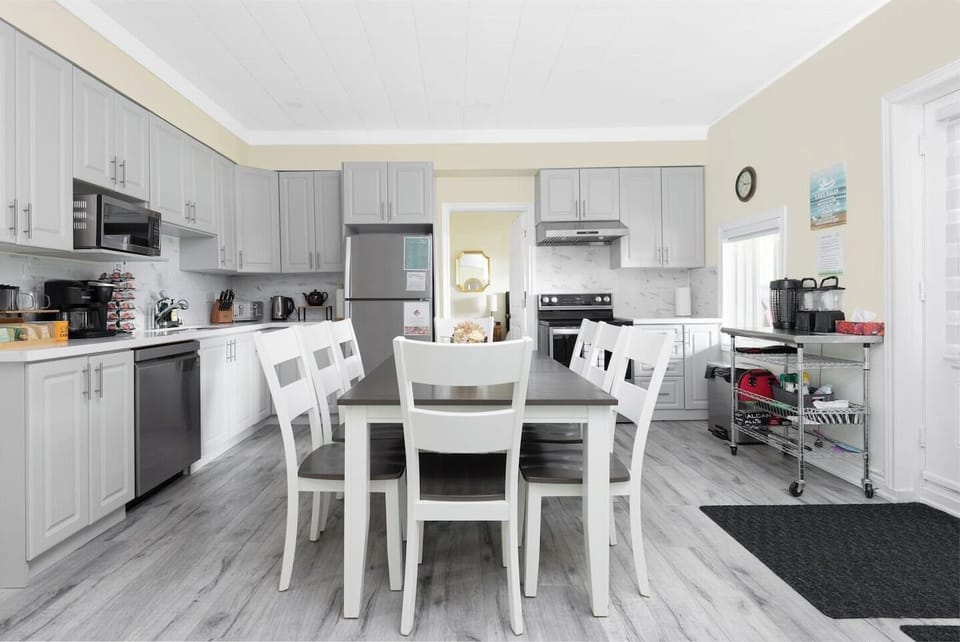 Fully equipped kitchen includes full fridge, freezer, range, microwave, toaster, Keurig coffee maker, kettle, pots/pans, dishes, drinkware, cutlery and cooking utensils. 