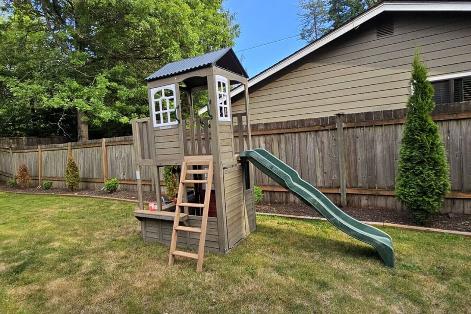 Kids playground featured in the backyard.