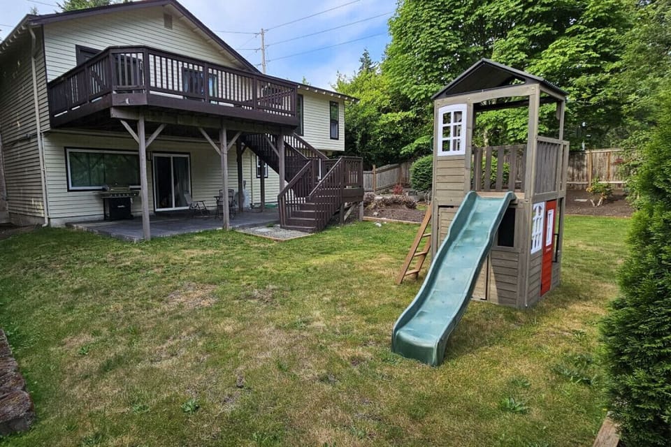 Kids playground featured in the backyard.