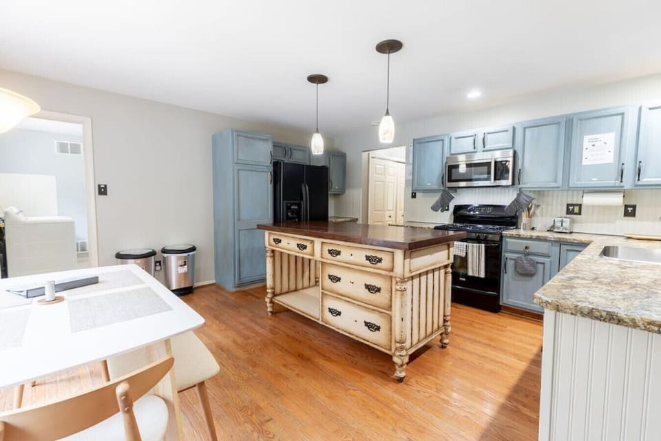 Stylish coastal kitchen with full amenities and a roomy island perfect for cooking together or serving casual breakfasts