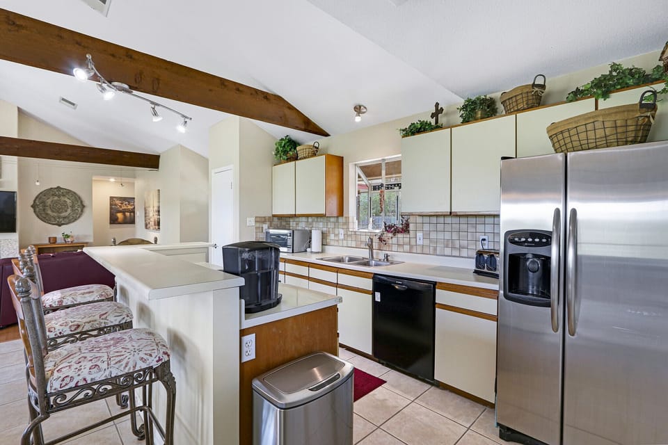 Full kitchen with stove, oven, refrigerator, dishwasher, and coffee maker