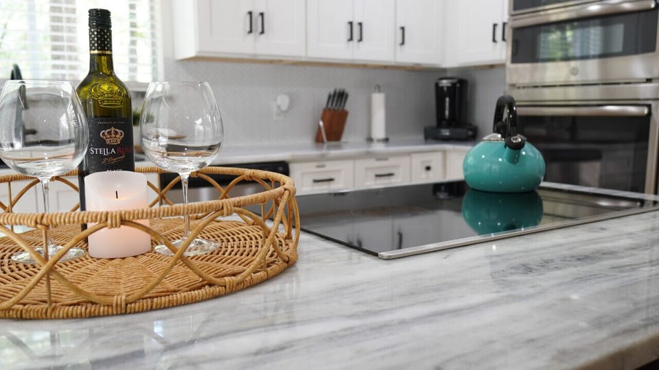 `Toast to Tranquility: Imagine your evening in this beautifully appointed kitchen, with a glass of wine in hand and a backdrop that’s straight out of a design magazine. It`s more than a stay—it`s an experience. #ElegantRetreat #WineAndDine #StayInStyle`