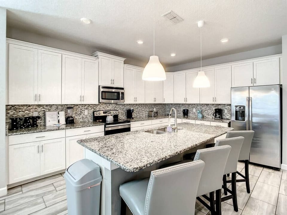 Enjoy casual meals or morning coffee at the kitchen counter with comfortable seating.