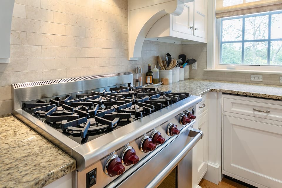 6 Burner Wolf Stove-top.  Kitchen has two ovens and a microwave.
