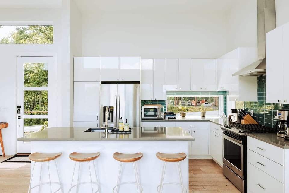 Barstools line the kitchen island for casual meals, morning chats, or keeping the cook company. It's a perfect space to gather while meals are prepped.