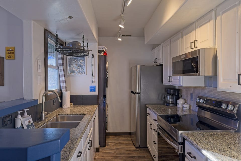 Fully equipped kitchen with espresso machine.
