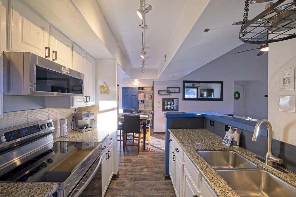 Modern kitchen design with ample counter space, dishwasher, and dining for 4 plus 3 at the breakfast bar.