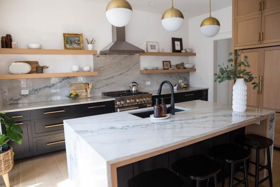 Custom chef's kitchen with a 6 burner gas range, full spice drawer.