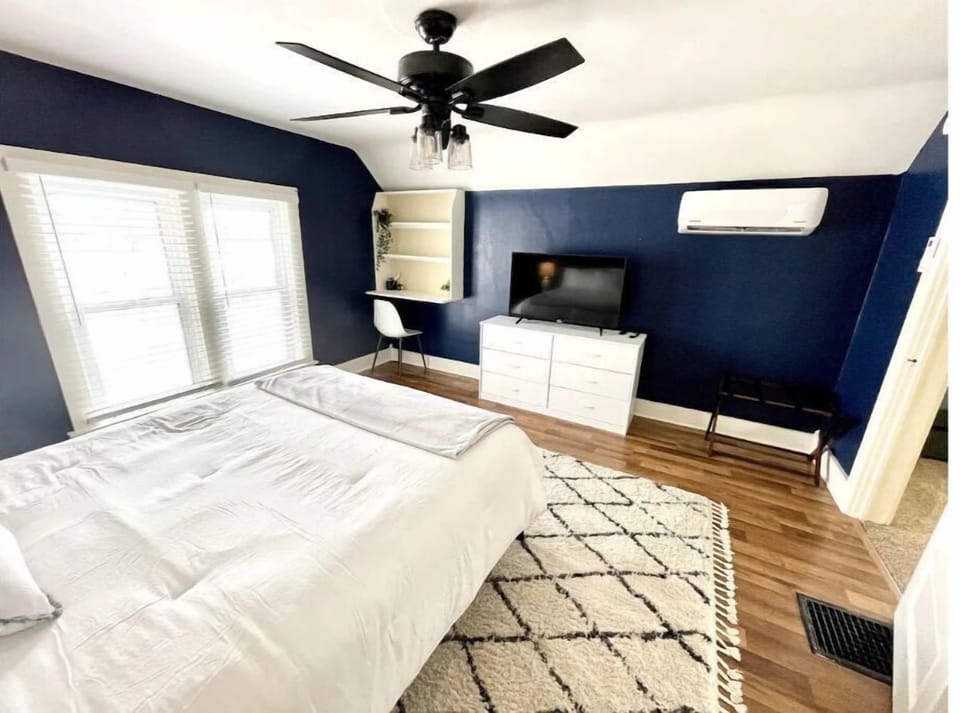 Large master bedroom with smart TV and desk area!