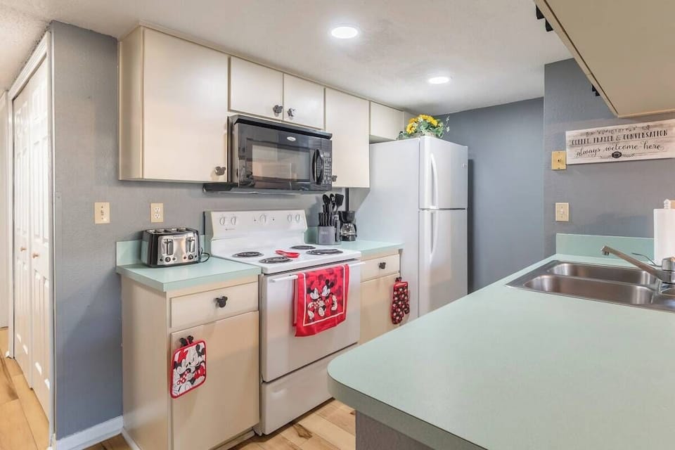Kitchen equipped with food pantry, dishwasher, and kitchen appliances with a nostalgic feel