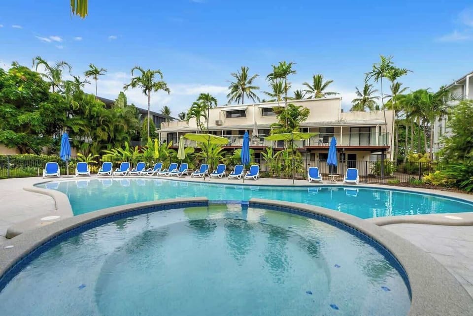 Pick a lounge chair and relax by the apartment's shared outdoor pool—with a spa to also enjoy.