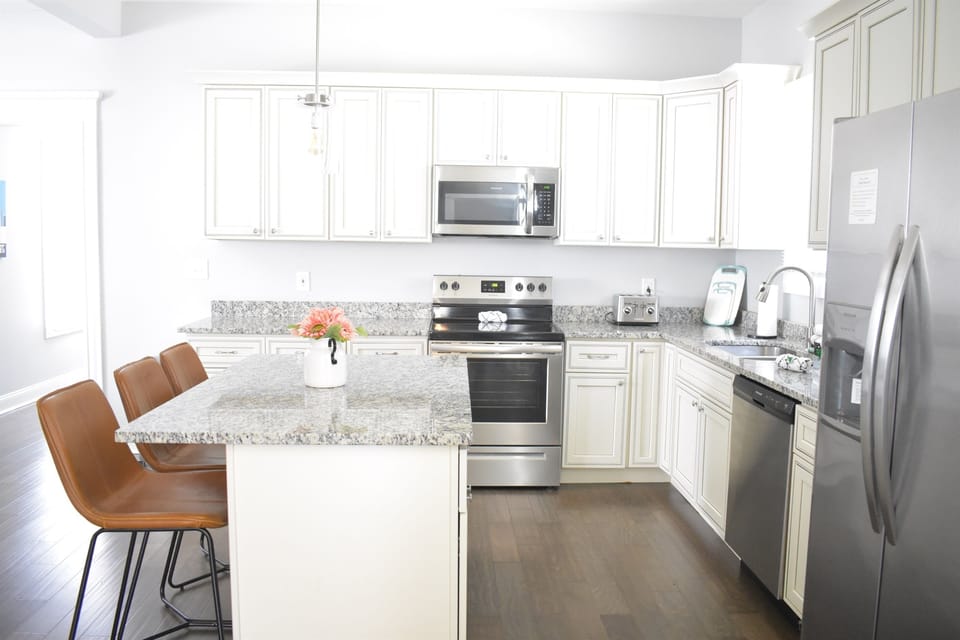 You’ll have plenty of counterspace, including in the kitchen island, plus all the cookware, bakeware, dishware, flatware, glassware, serving-ware, and utensils you need for your favorite recipes. Barstools provide supplemental dining seating.