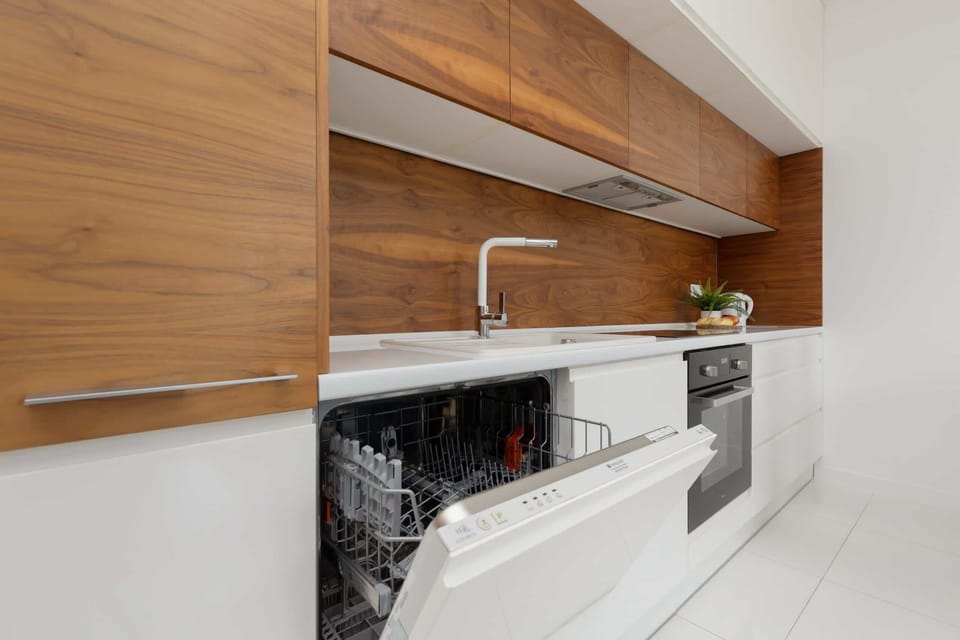 Kitchenette with plenty of kitchen utensils and dishes. 