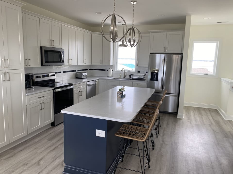 Kitchen with coffee maker, bar seating and 2 dish washers.