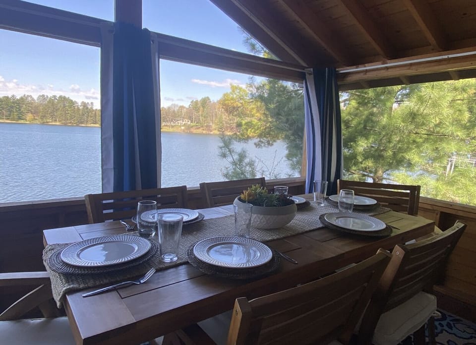 dining room in screen porch overlooking lake