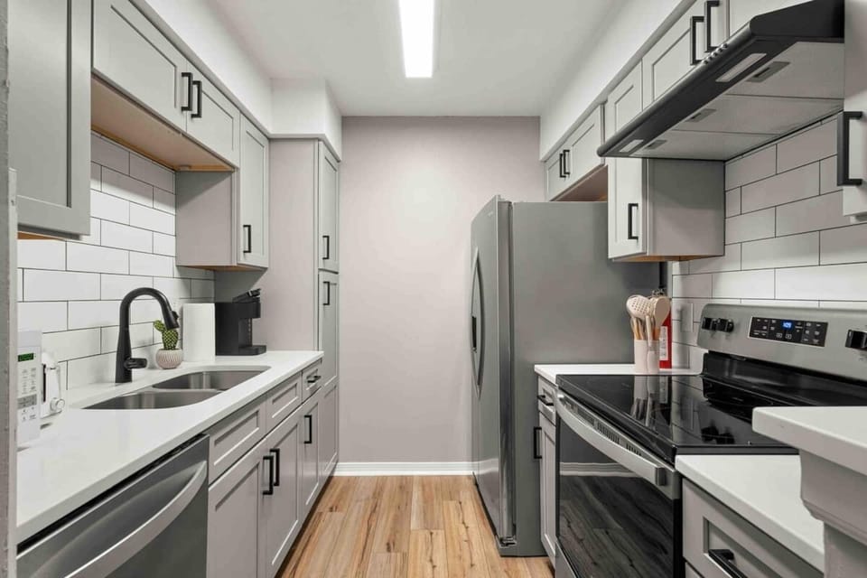 Kitchen view to dining room. All new cabinets and quartz counters. Stainless steel appliances, microwave, toaster, keurig coffee maker. Deep sink. Faucet with spray nozzle. Dishwasher 