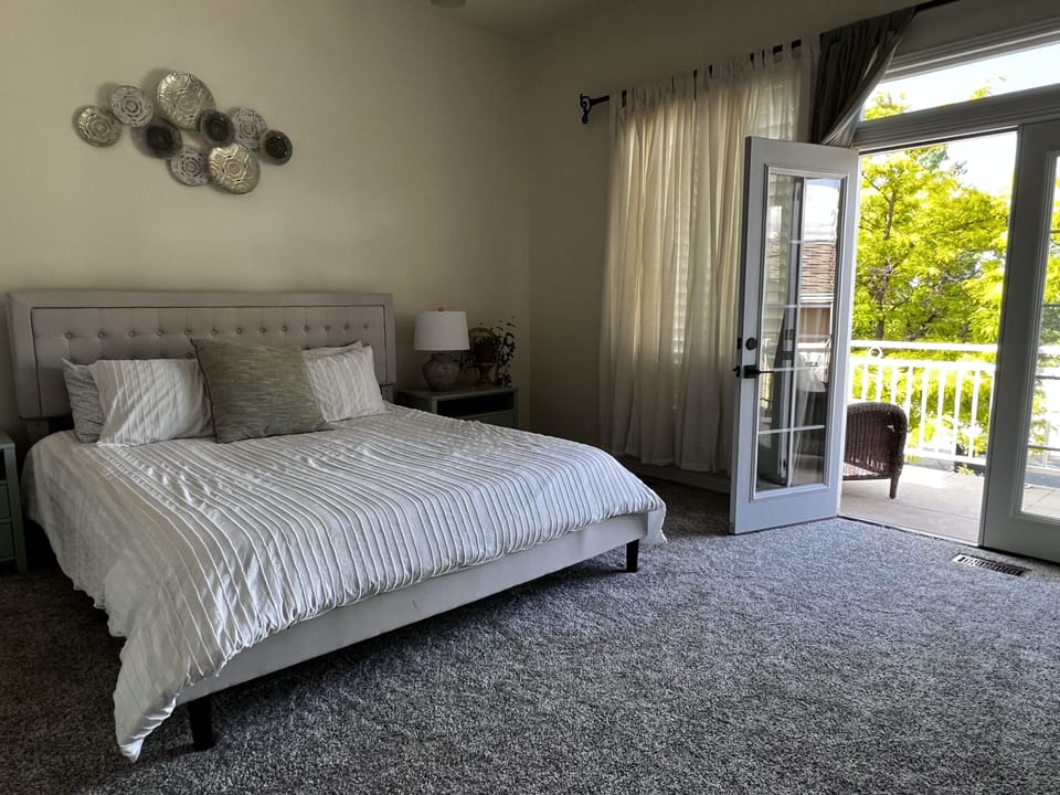 Large master bedroom features a king size bed and private balcony