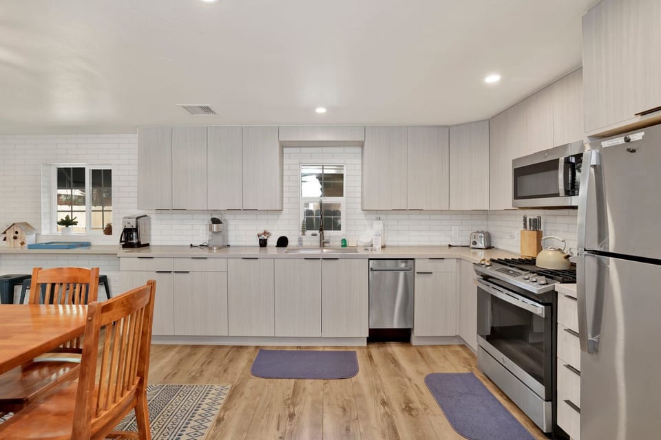 Fully equipped cabin kitchen with ample cabinetry, stove, fridge, microwave, and coffee maker—perfect for cooking meals, morning coffee, and feeling right at home on your stay.