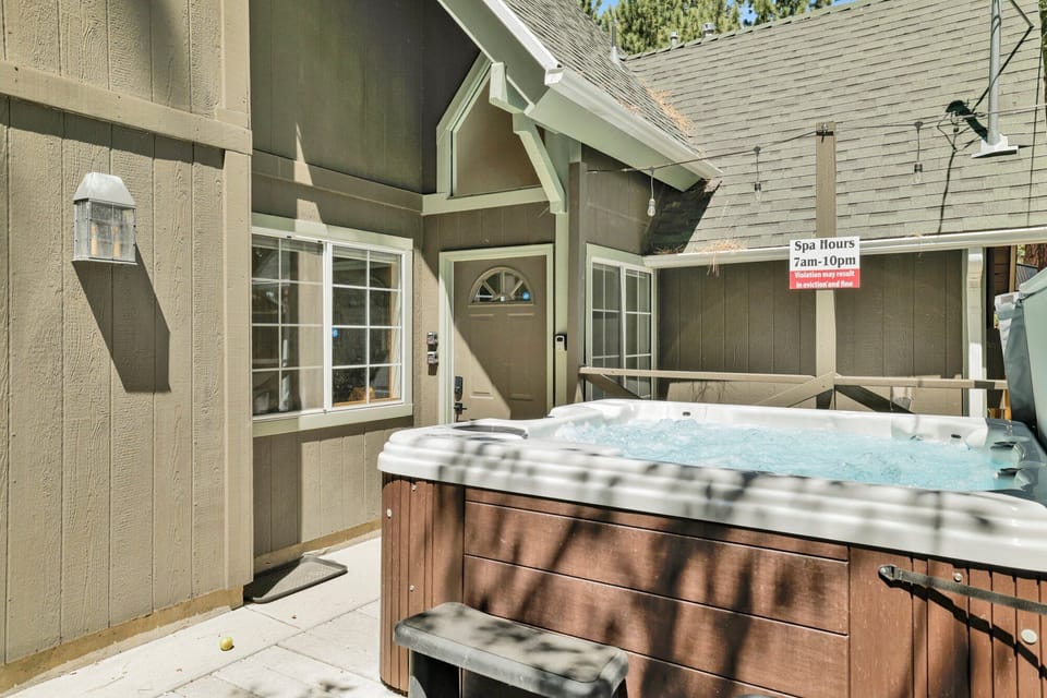 Private outdoor hot tub, surrounded by tall pines, perfect for relaxing under the trees after a day of adventure—enjoy peaceful forest views, fresh air, and a truly rejuvenating stay.