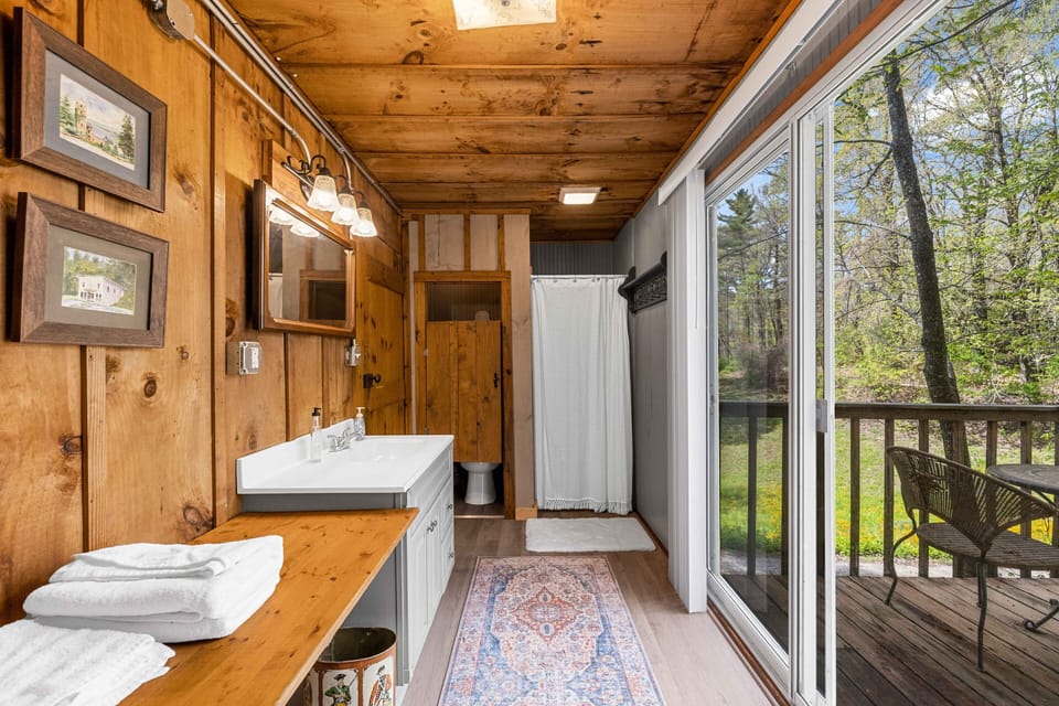Bathoom, with the toilet on the left, single shower on the right.