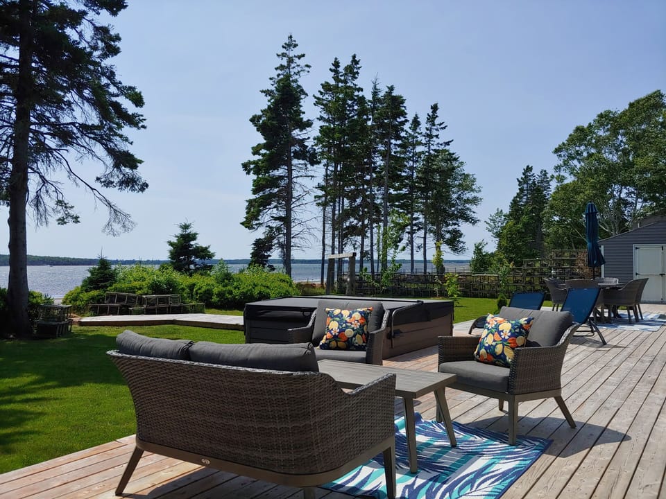 Large deck with furniture and hot tub