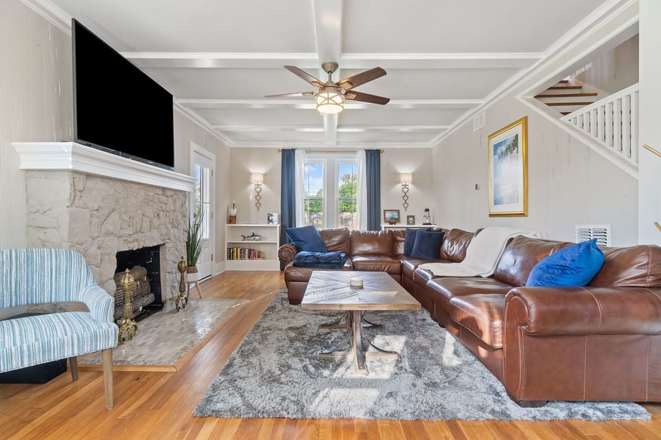 Relax in the comfortable living room with a 70-inch TV & 6-person leather couch!