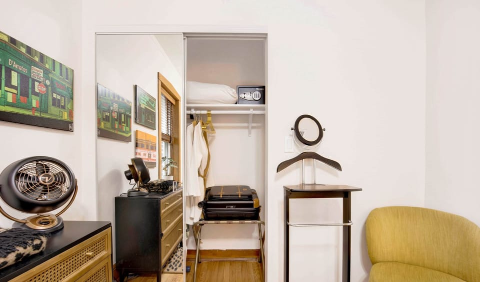 Bedroom 2 (Center) equipped with dresser, nightstand, tray table, side chair and valet stand