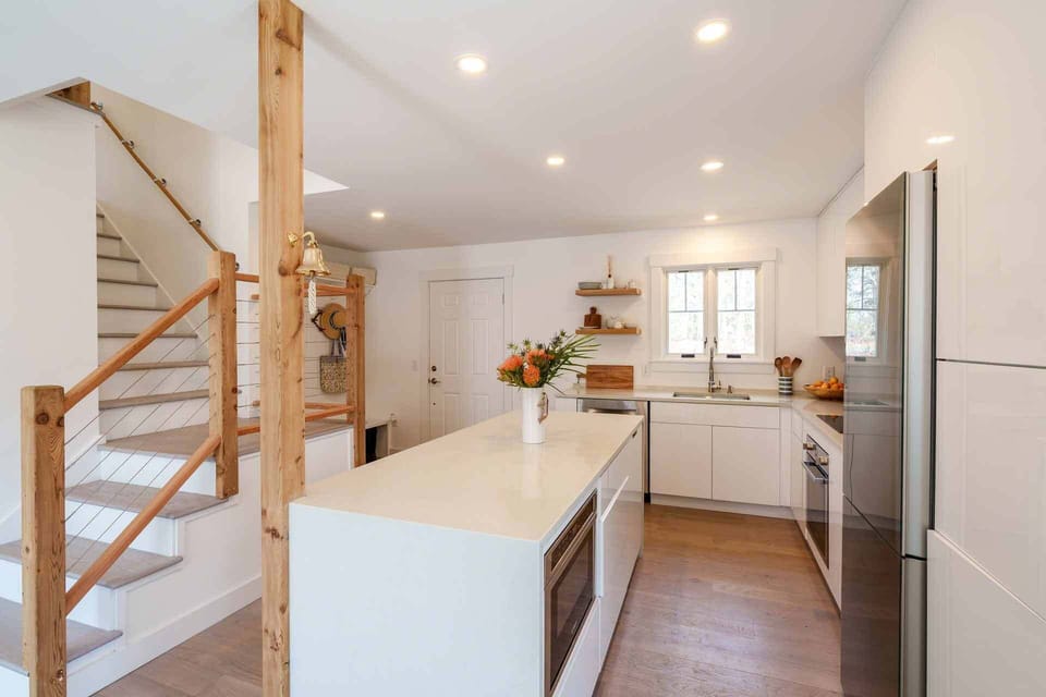 Kitchen has a Center Island with Corian Counter Top and Breakfast Bar with 3 Stools