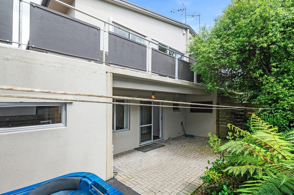 The courtyard is sheltered by ferns with a line for drying towels.