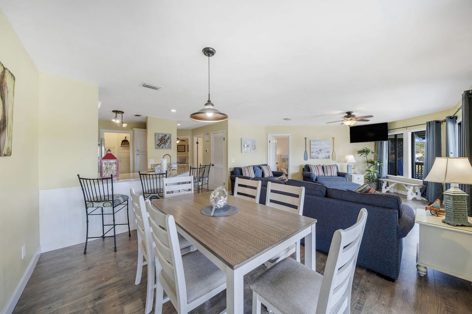 This condo has a dining table, as well as additional breakfast bar seating.