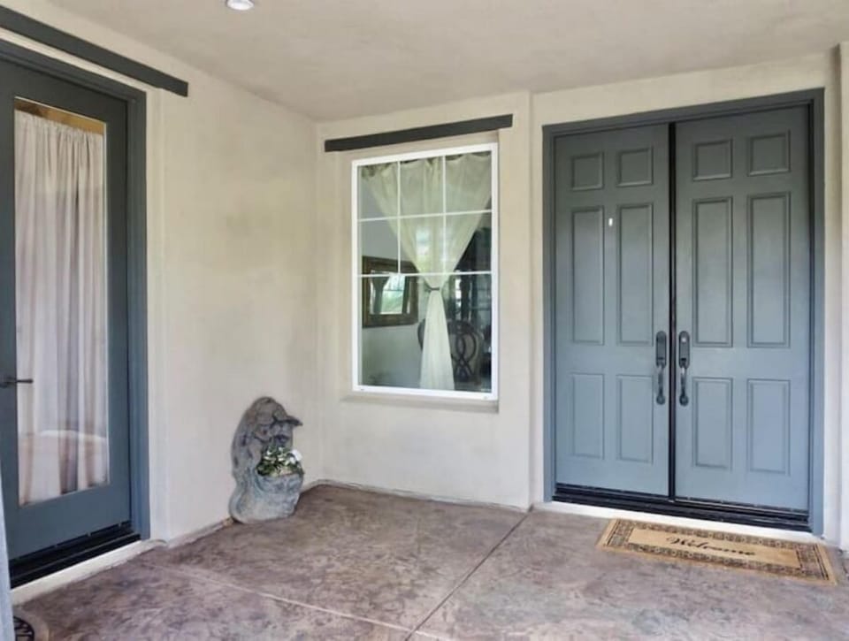 front courtyard. French door to main house and french door to guest bedroom