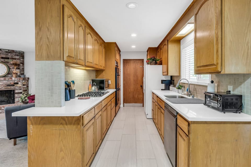 Fully stocked kitchen with gas stove and double ovens