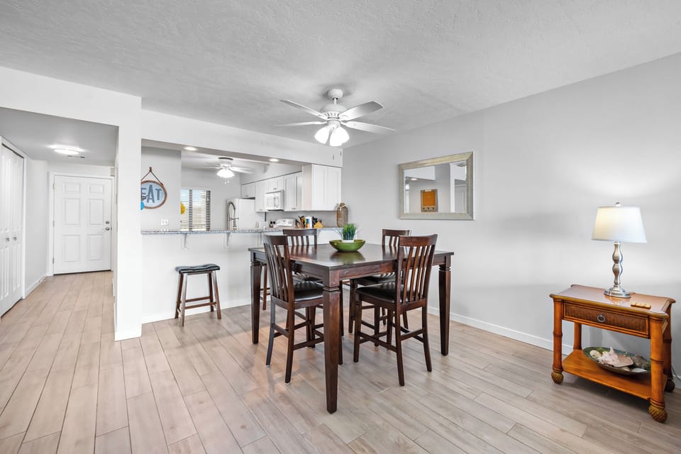 Kitchen with counter with bar stool chair plus dining area to gather.