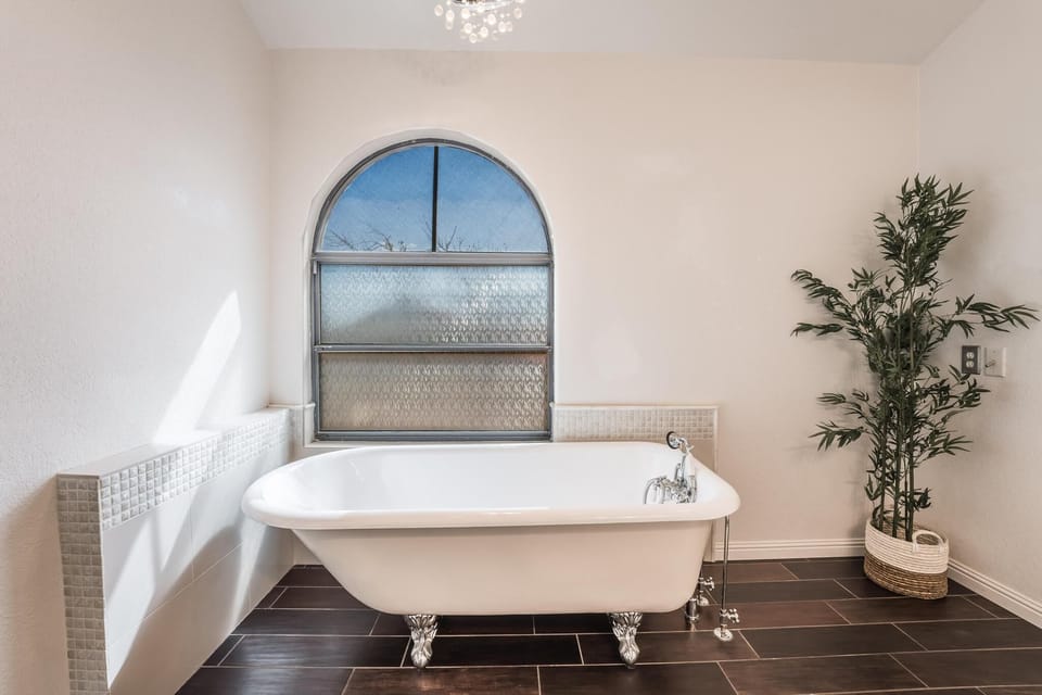 Master bathroom with tub and stand up shower.
