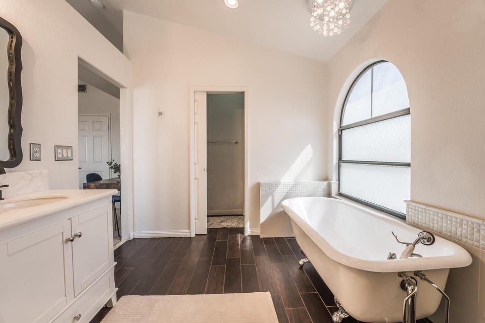 Master bathroom with tub and stand up shower.