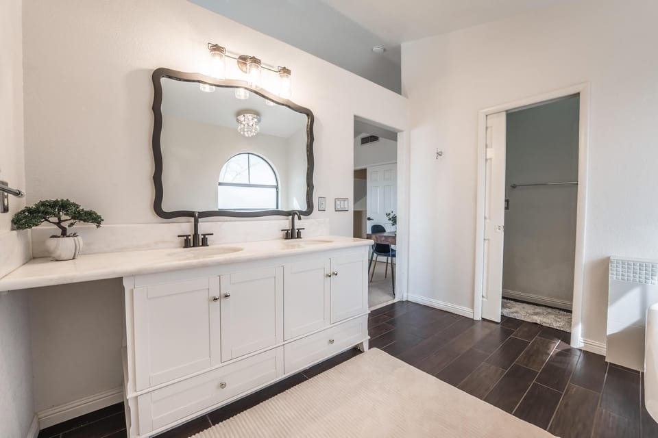 Master bathroom with tub and stand up shower.