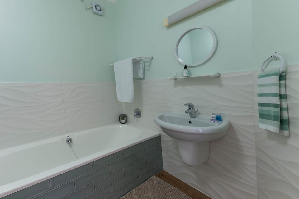 A bathroom with a bath