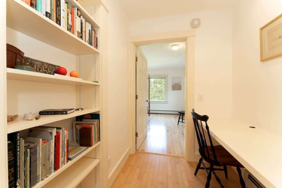 Work space and little reading library in hallway between front hall and main bedroom.