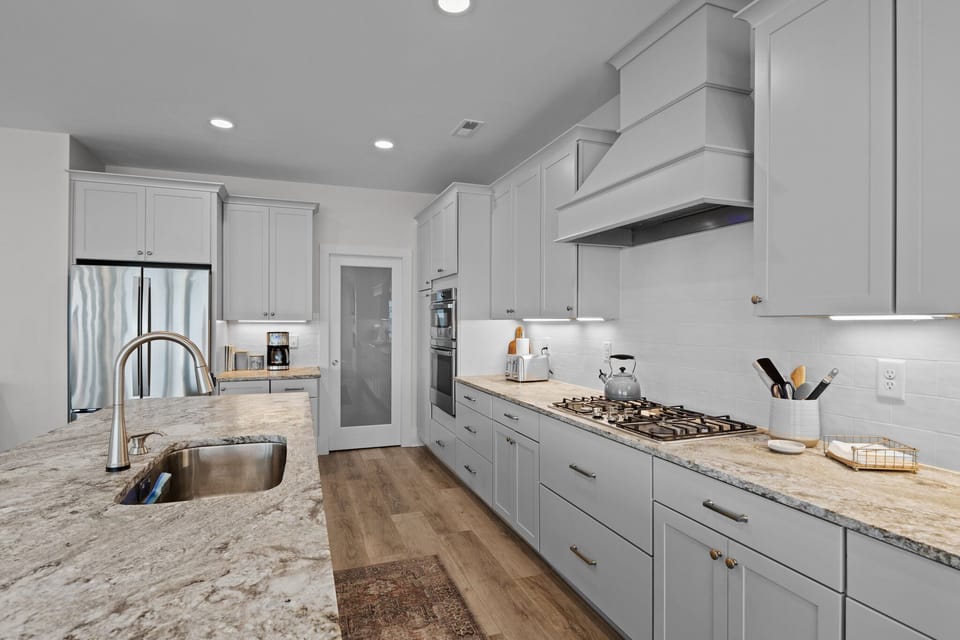 You'll love cooking in this bright, modern kitchen with granite counters, stainless appliances, and plenty of prep space for your vacation meals.